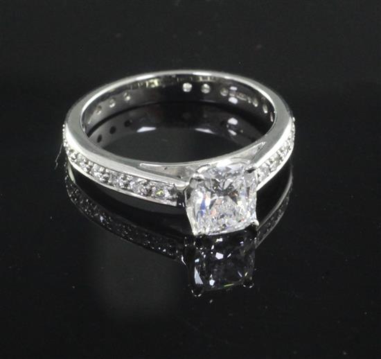 A modern platinum and single stone diamond ring with diamond set shank, size M.